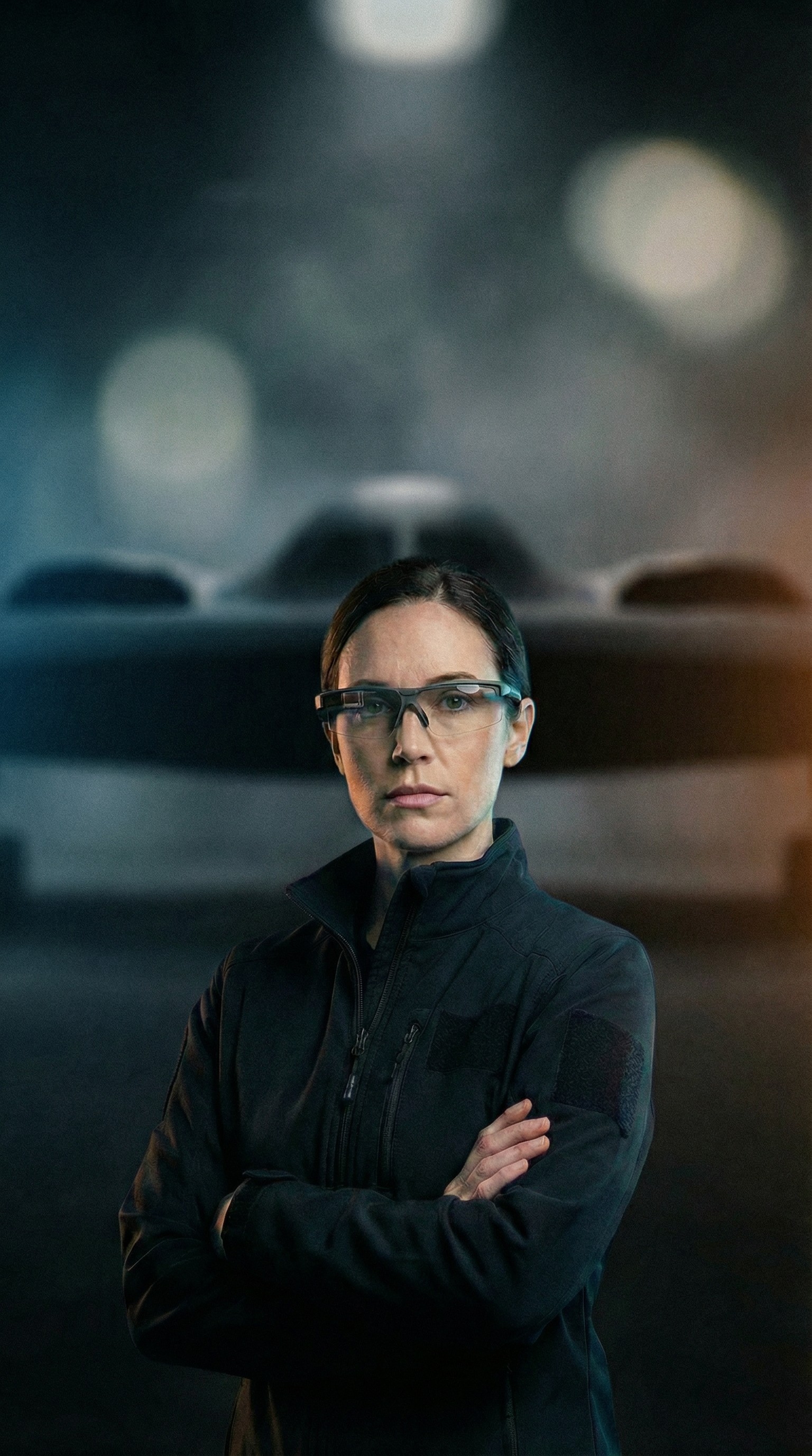 Female scientist wearing a white coat and gloves examines a sample slide in a modern laboratory setting.