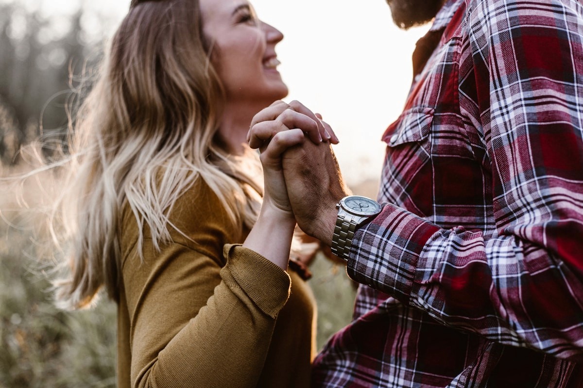 Couple holding hands near trees