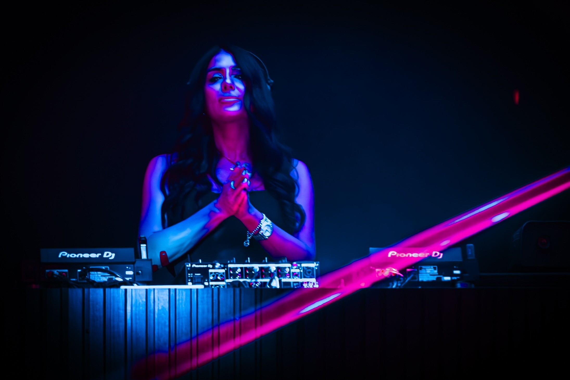 EVNIA performing under blue and magenta lights
