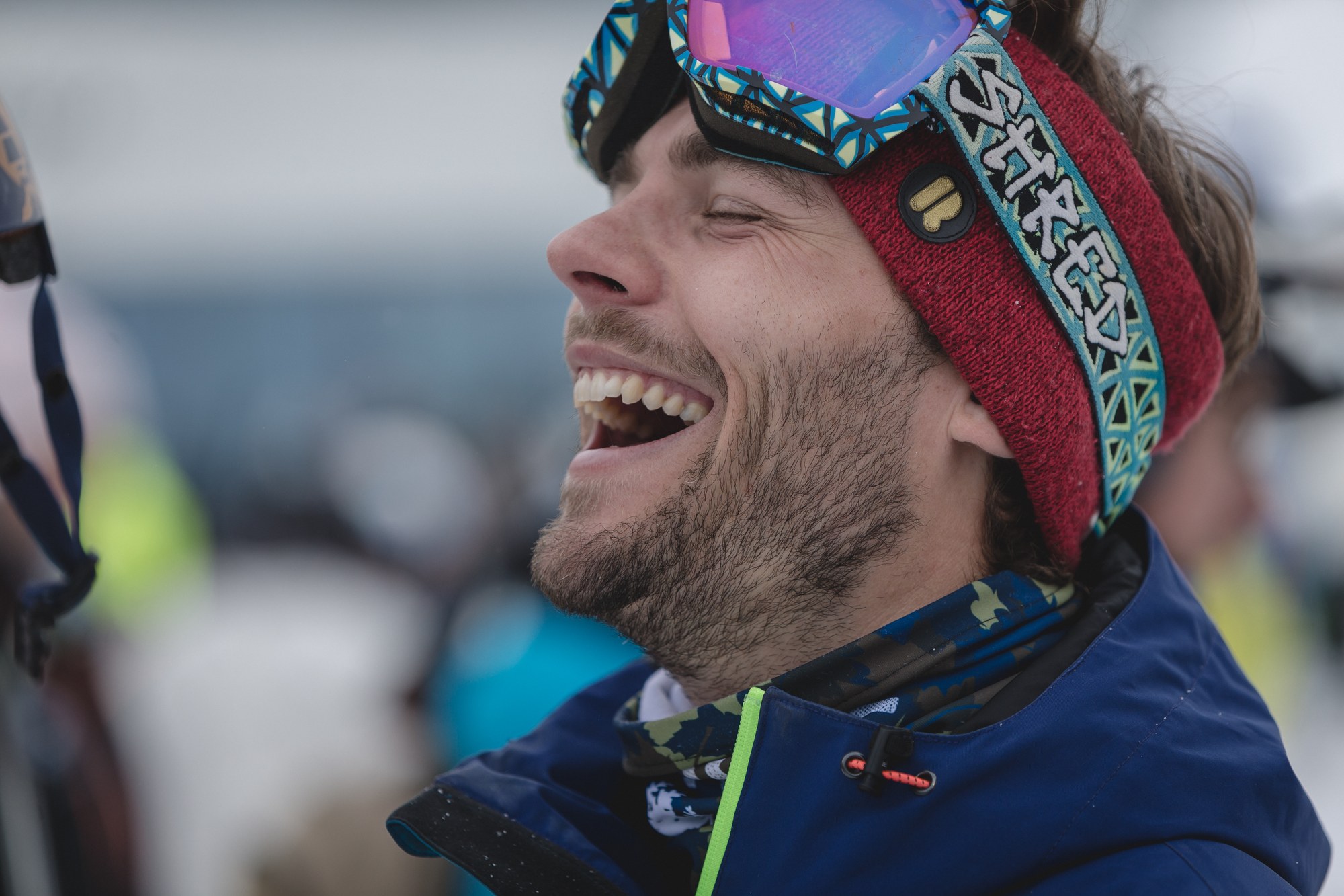 Laughing face close-up in the snow on a SportScheck shoot — emotion instead of advertising copy was the core of the campaign
