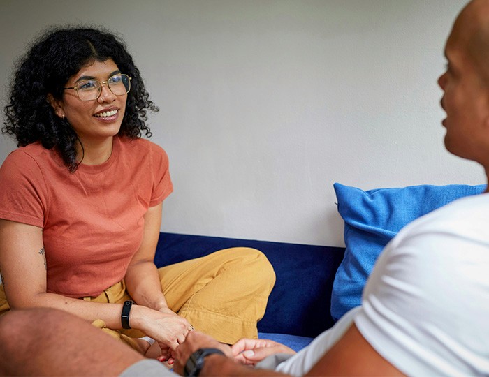 Support worker listening attentively to a client in a welcoming day centre.