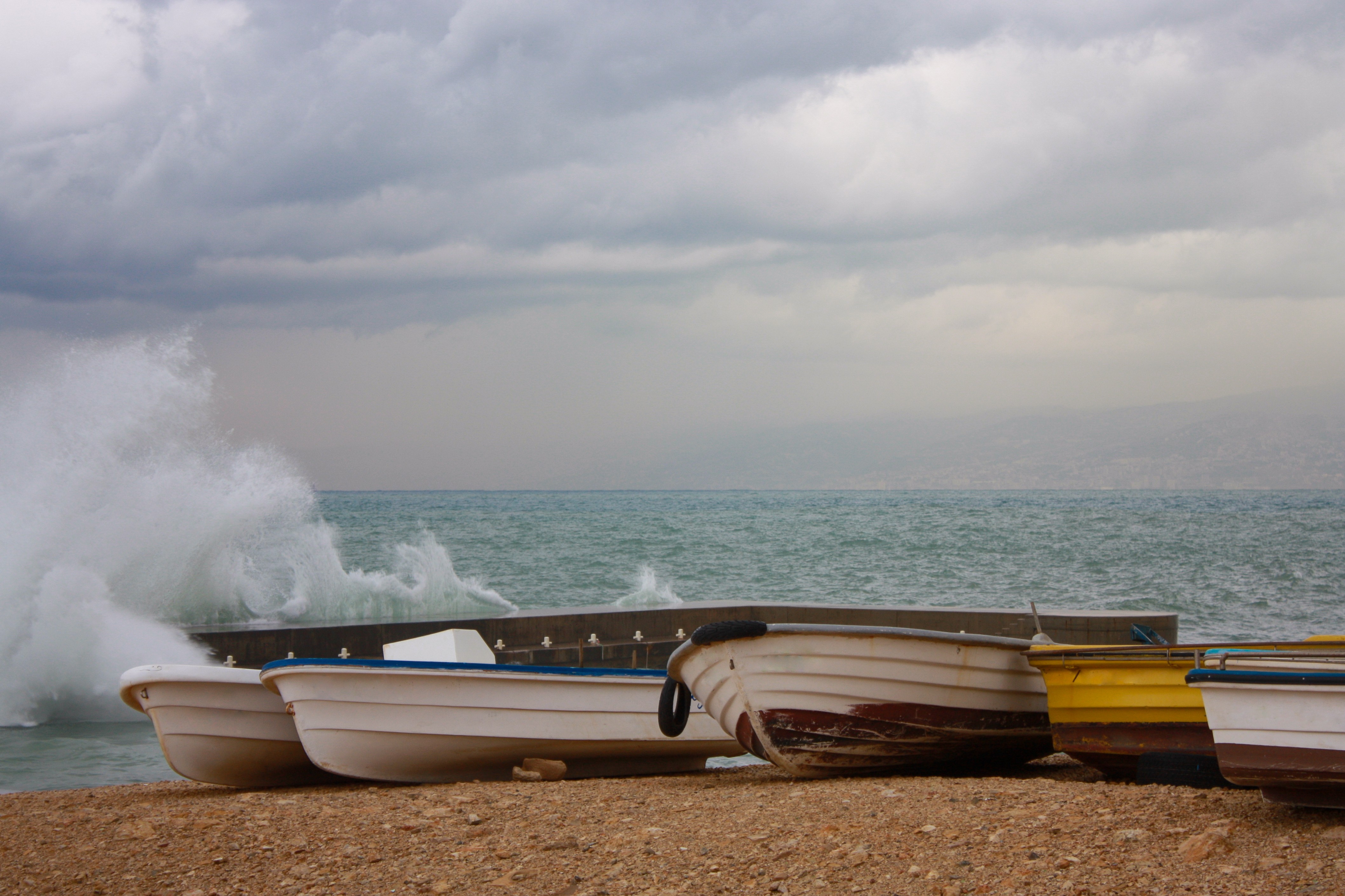 Boats on the shore of the Mediterranean Sea in stormy weather in Beirut, Lebanon