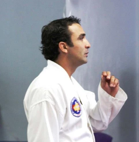 A younger Mr Millan talking to class.