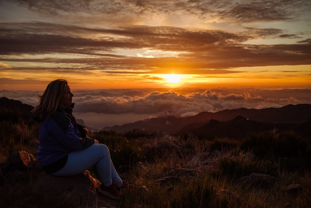 Lexi watching sunrise from the top of a mountain in Madeira