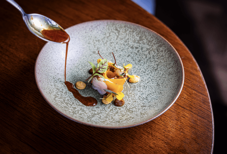 fish dish with light green sauce