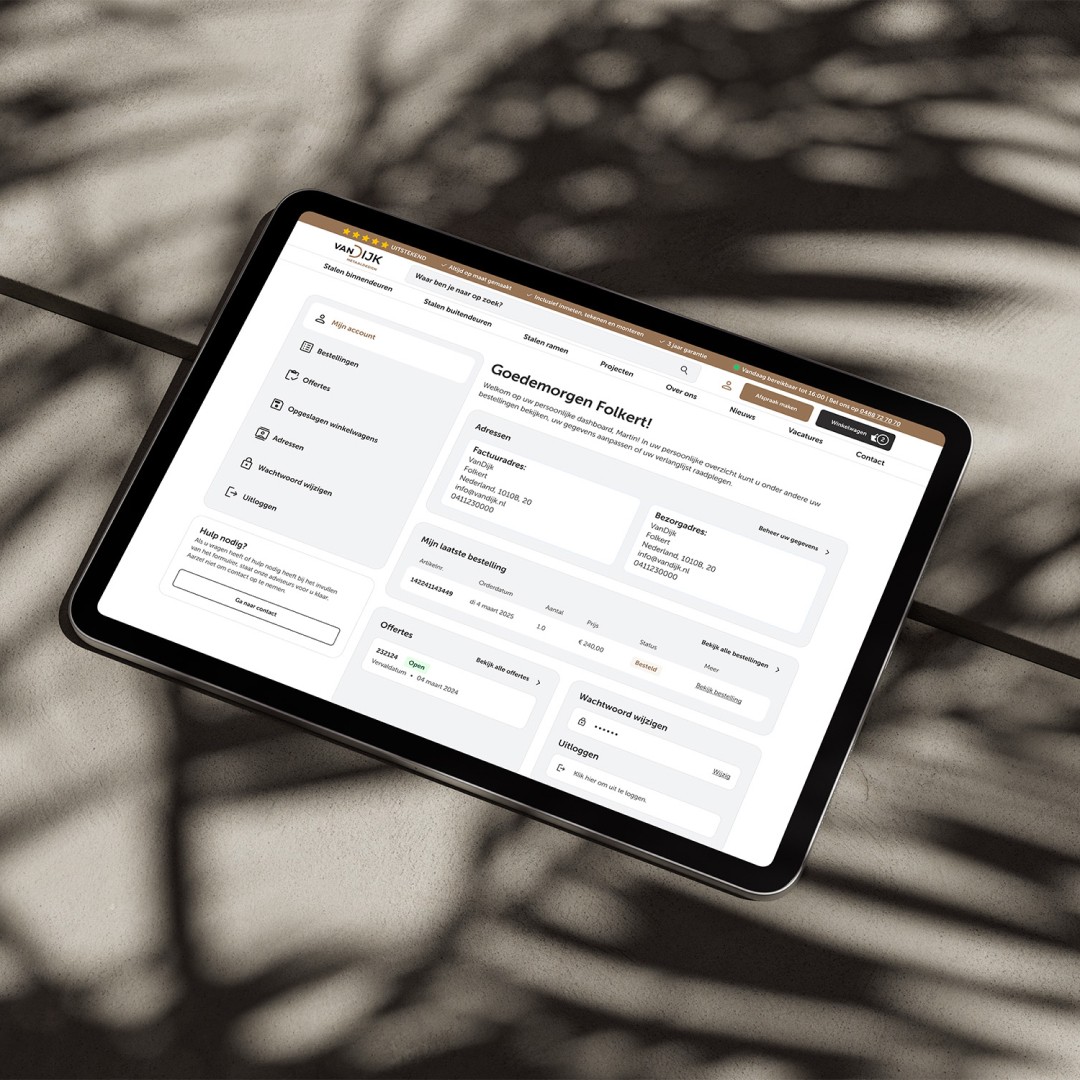 Modern home office setup with a monitor, ergonomic chair, keyboard, and indoor plants near a window with blinds.