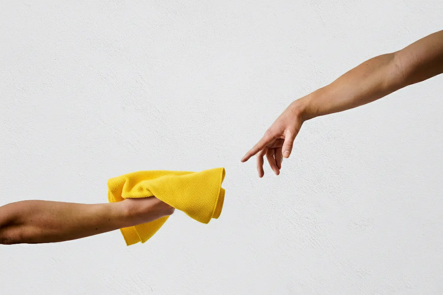 persons hand on white wall