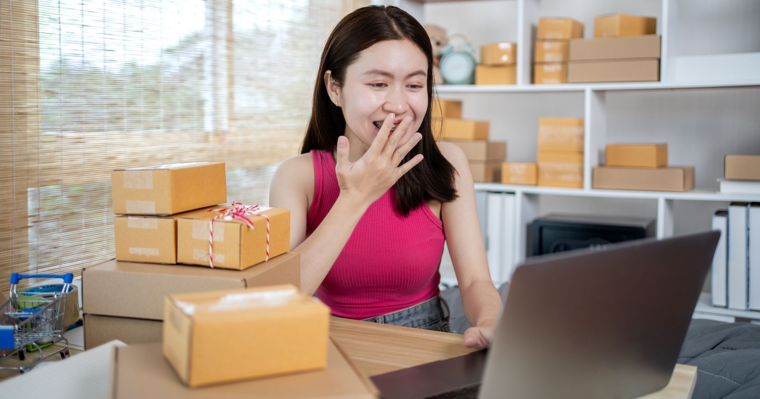 An online seller woman celebrating successful online sales