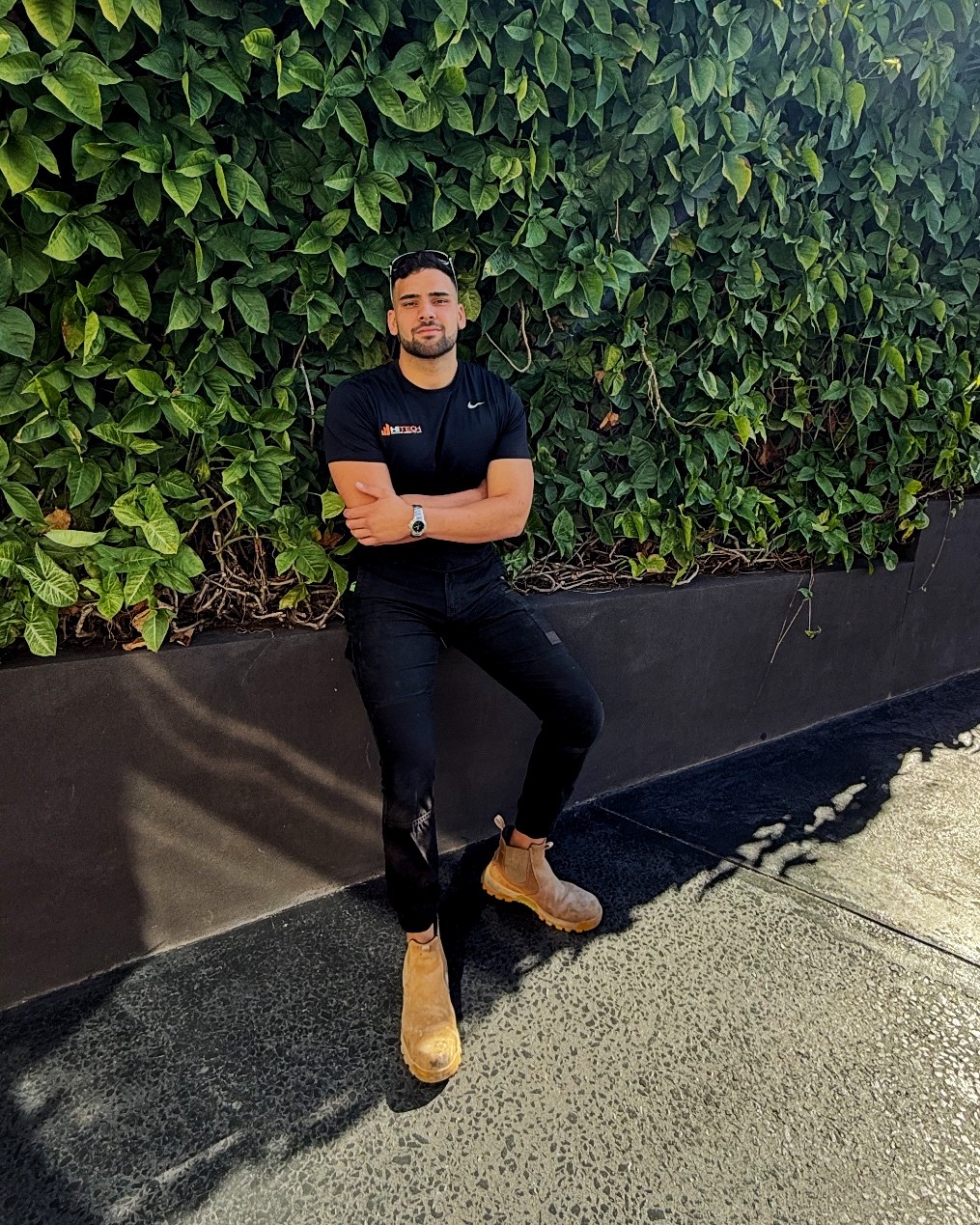 Spacious, luxurious living room with high ceilings, an elegant beige sectional sofa, warm ambient lighting, classical artwork, and rustic architectural elements, featuring an open layout with a view of a mezzanine level.