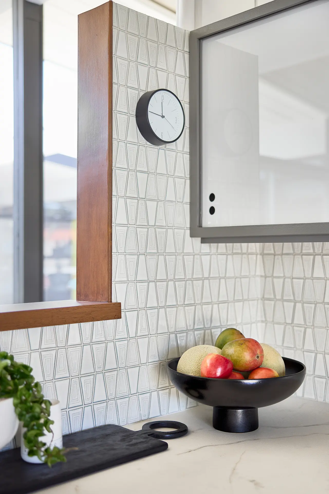 Close-up view of the kitchen backsplash, showcasing the retro tile design in the Fairhaven Eichler Tract remodel. Photo by Todd Huge.