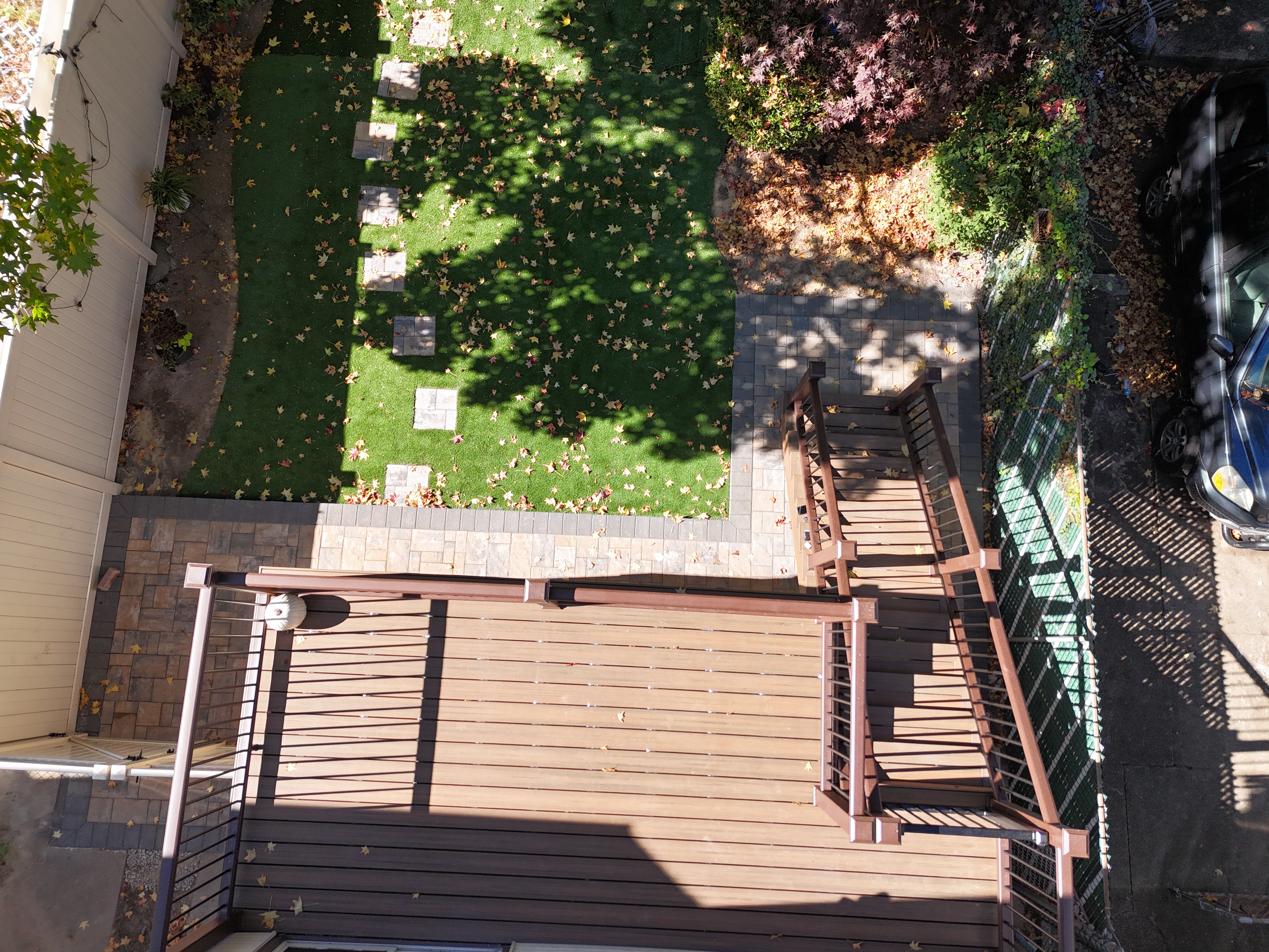Custom Trex composite deck stairs with picture framing, recessed lighting, and Transcend railings in Queens, NYC
