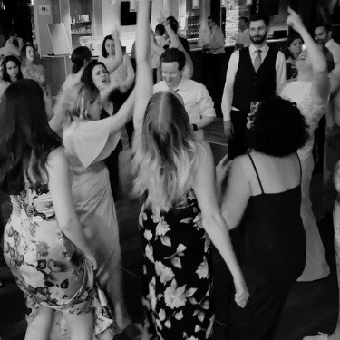 A group of ladies dancing joyfully with the bride at a wedding in Blue Mountain, Ontario, with NightStyle DJs providing the perfect soundtrack for the celebration.