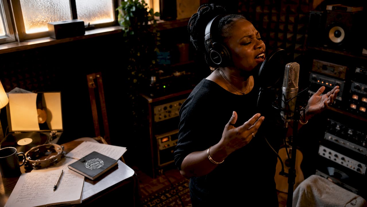 Artist singing in studio booth