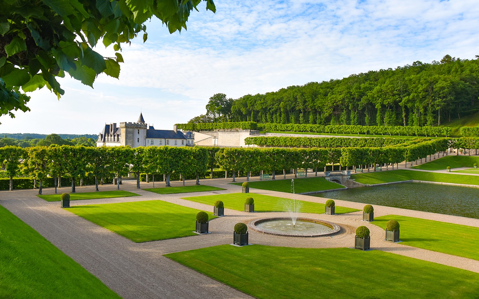 Water Garden at Château of Villandry with fountain and manicured hedges.
