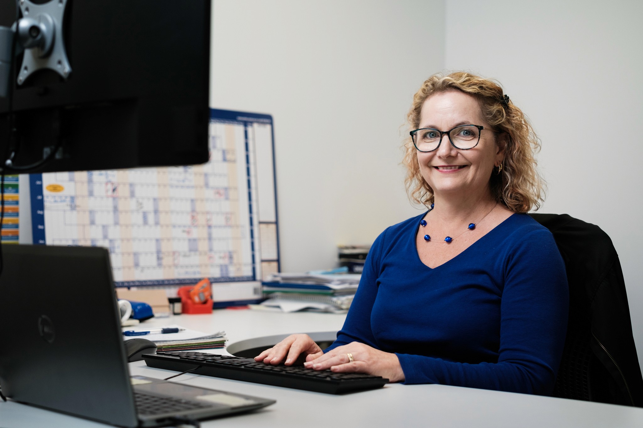 A woman works at a computer