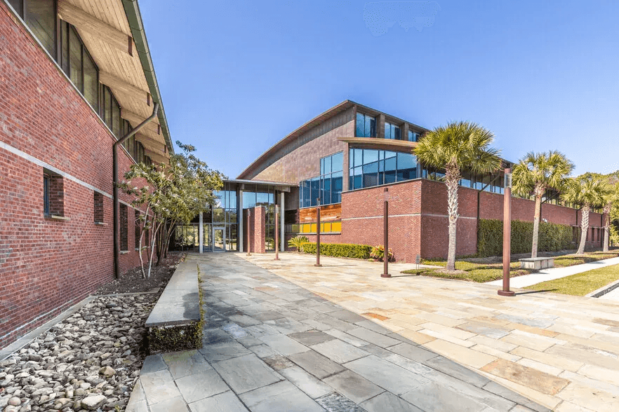 Exterior of a building with orange awnings and a sign above the door that reads “Prospect.”