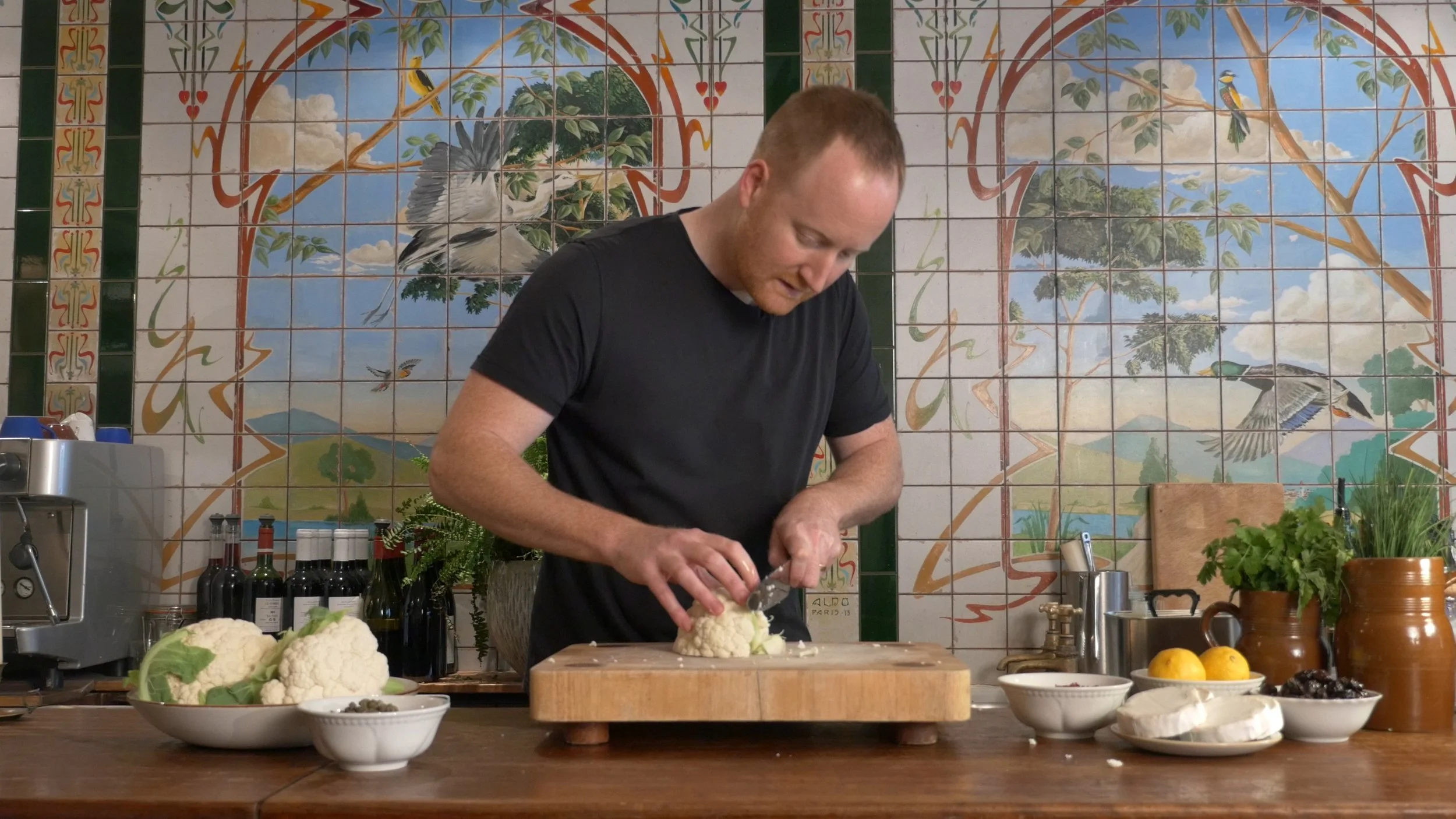 Rob Wade at a kitchen bench preparing food