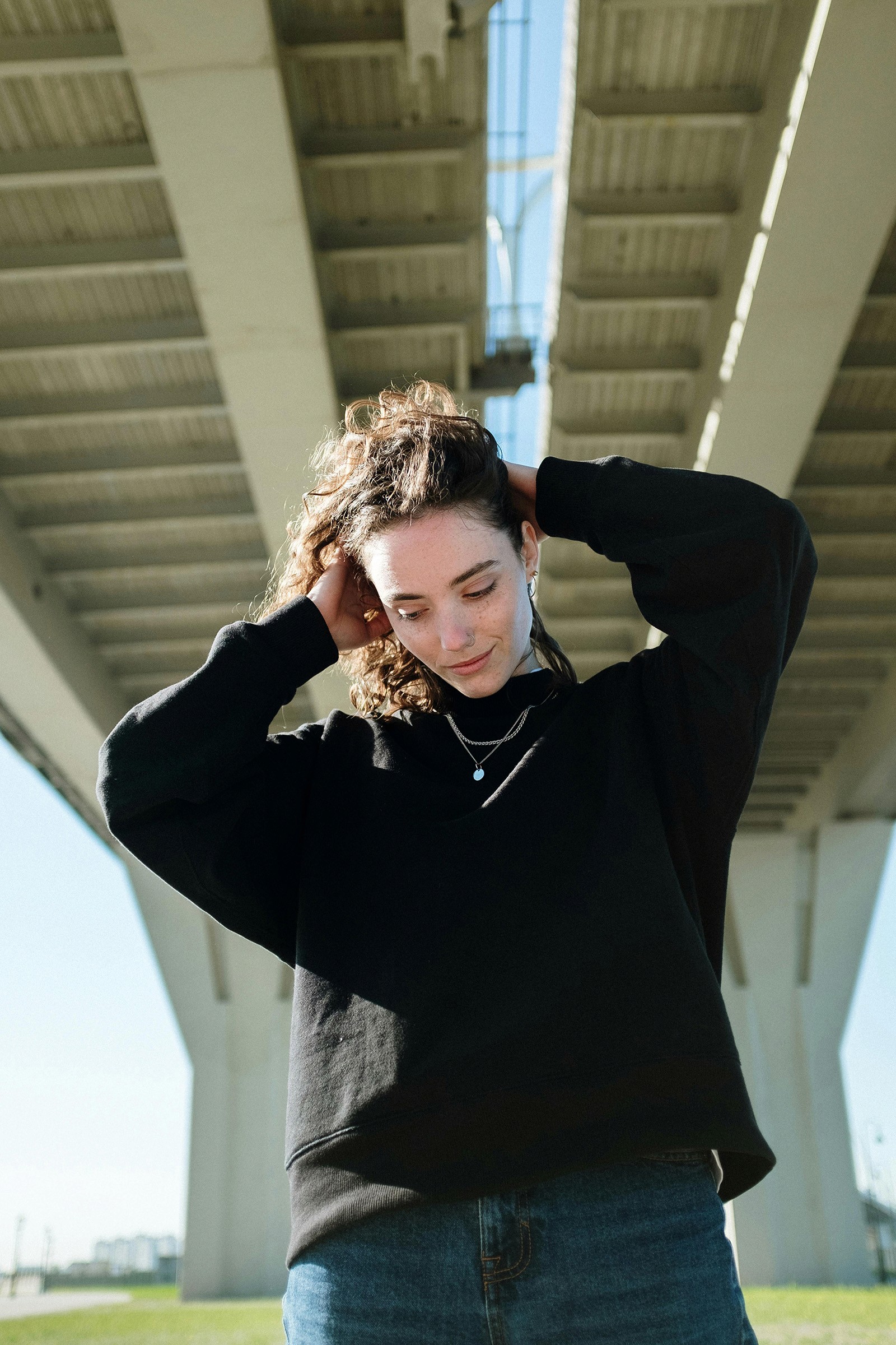 Beautiful girl holding her hair above her head