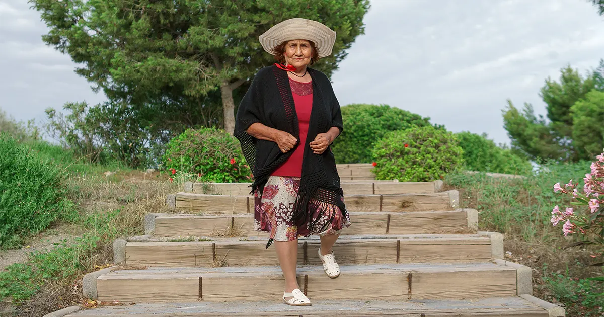 “Older woman walking down stairs.”