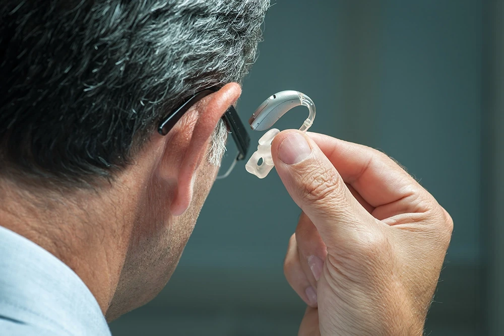 Man sitting in a testing booth having a hearing test