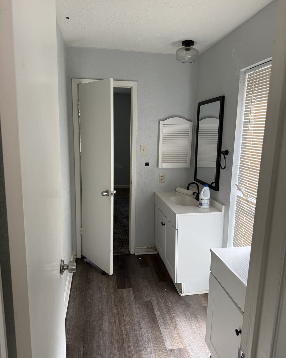 Before: Bathroom vanity area in warm greige