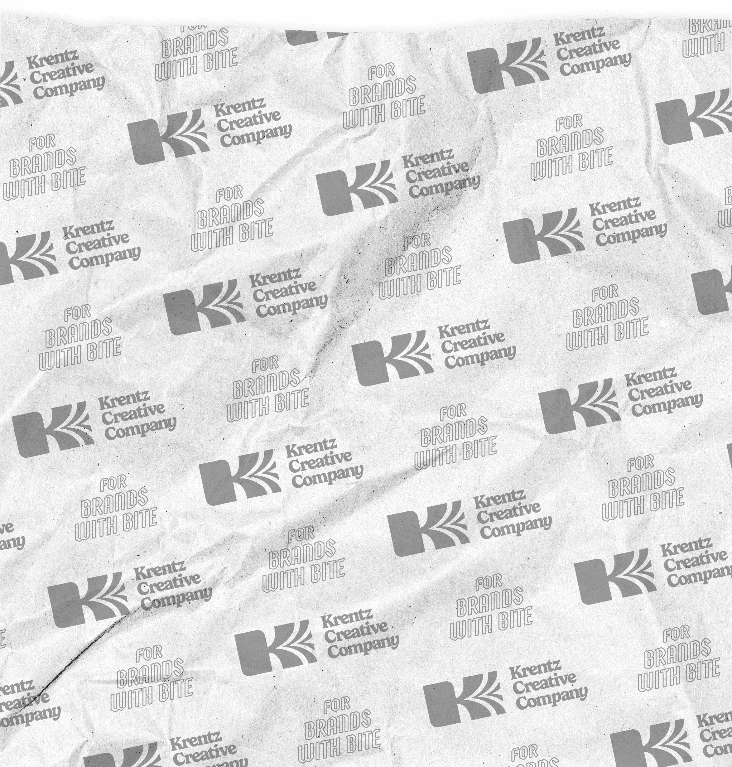A background image for the GRUB blog featuring a repeating pattern of the Krentz Creative Company logo, which is intended to look like printed food wrap