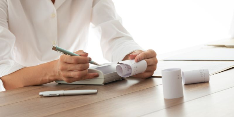 A Malaysian F&B business owner organising his business' receipts