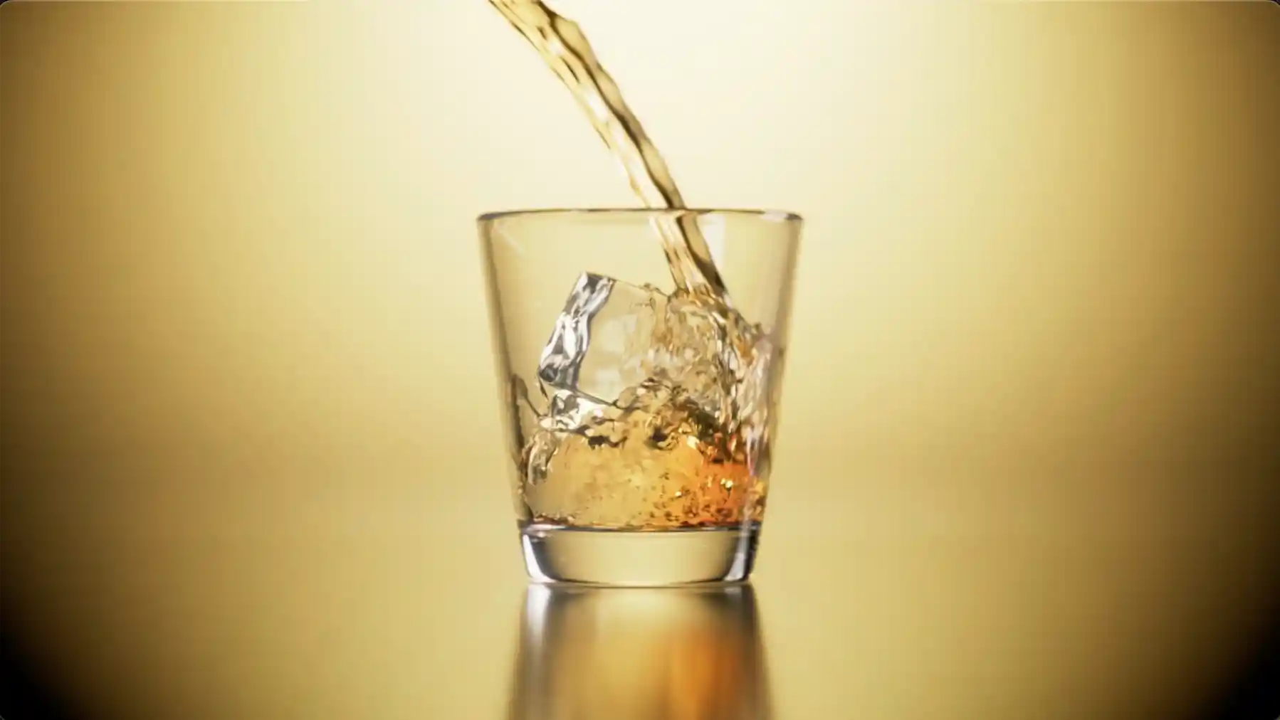 Whisky pouring over ice into a tumbler, CGI liquid simulation