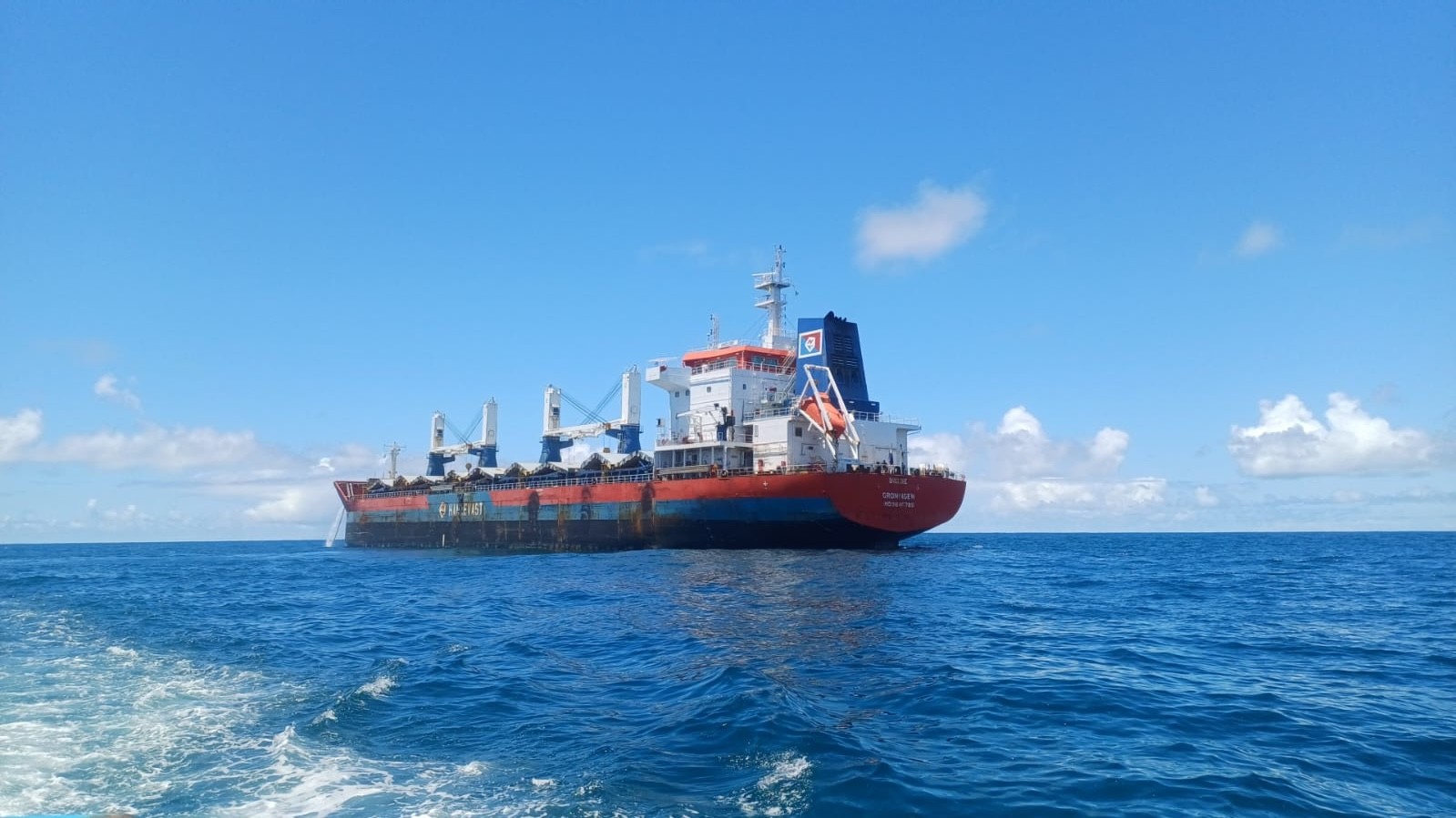 Bulk carrier UNIGLOBE at Paranaguá Anchorage, Brazil, viewed from the sea during cargo hold cleaning and inspection attendance.