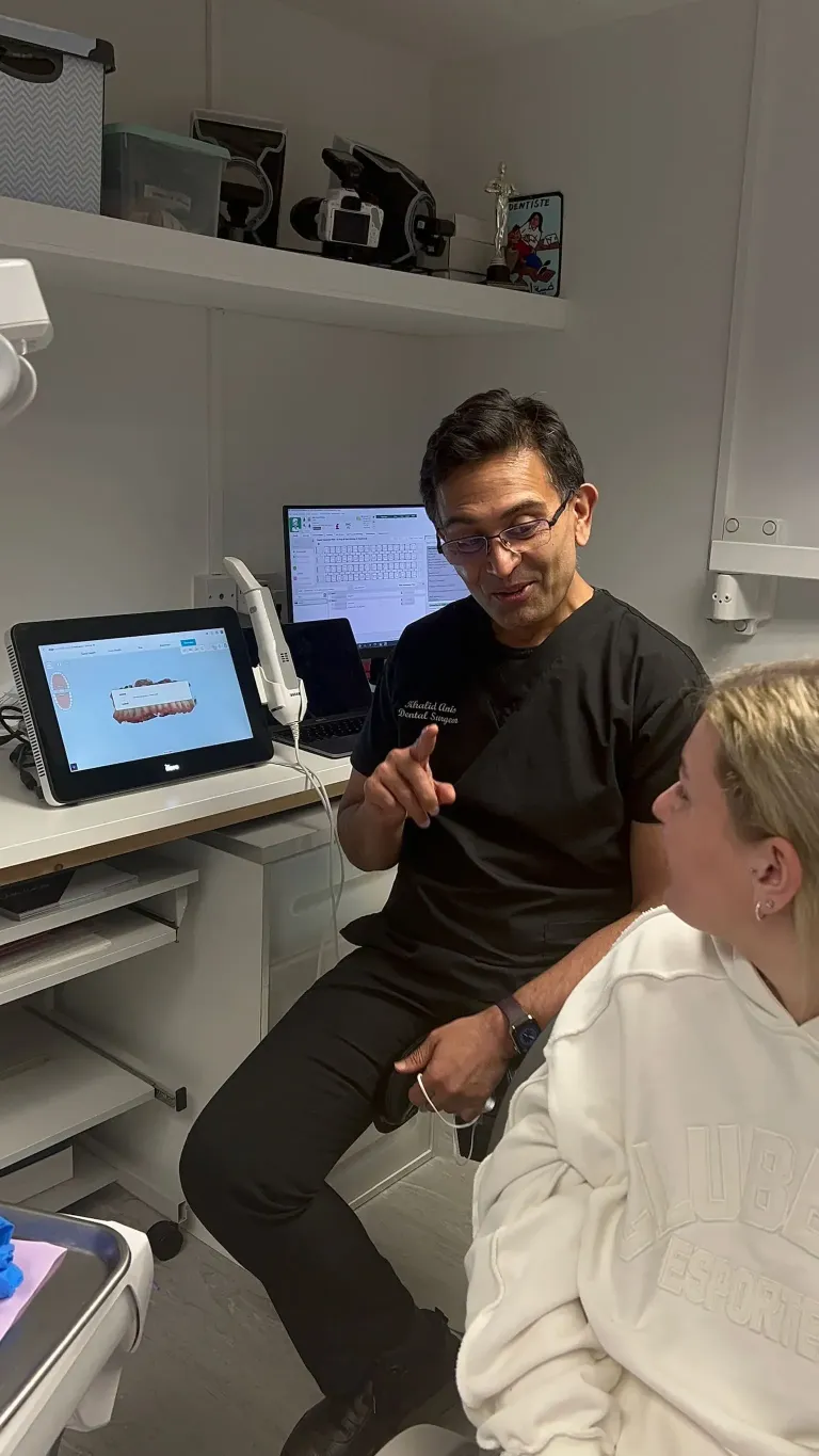 Dr Khalid speaking to a patient about their clear aligners and their teeth.