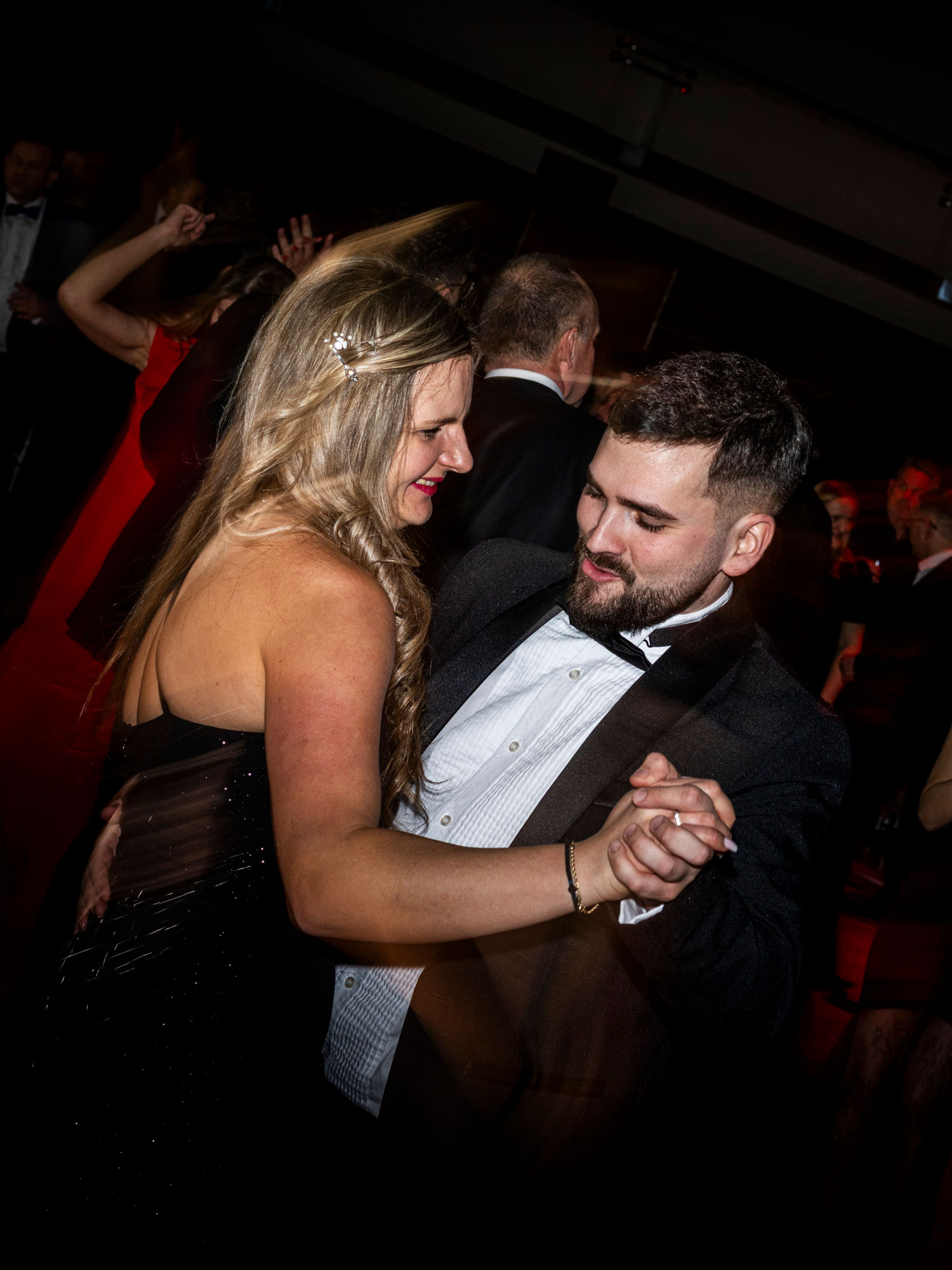 Brand ambassador engaging with visitors at a sponsor booth during a corporate event.