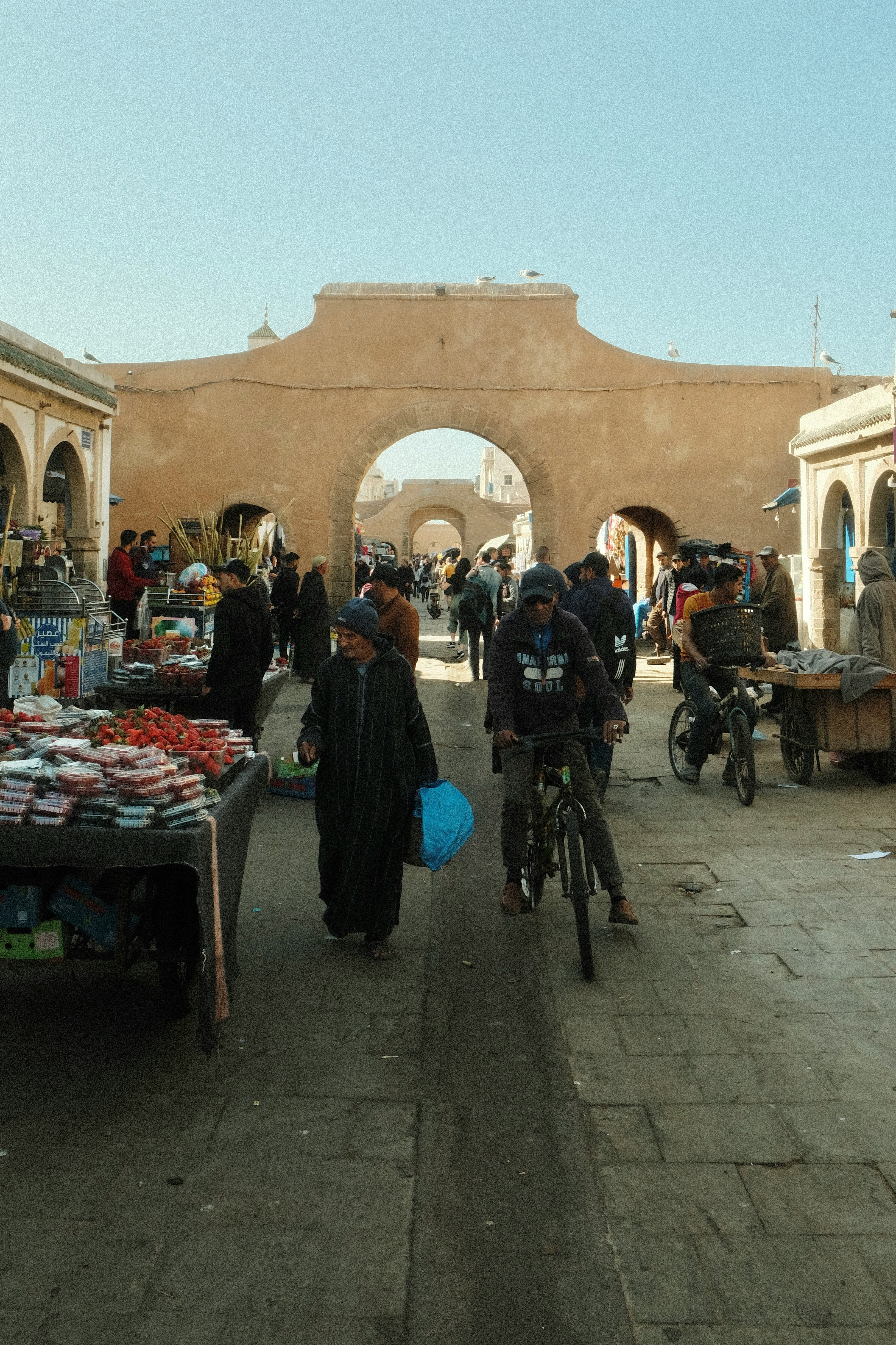 A group of people walking around a market