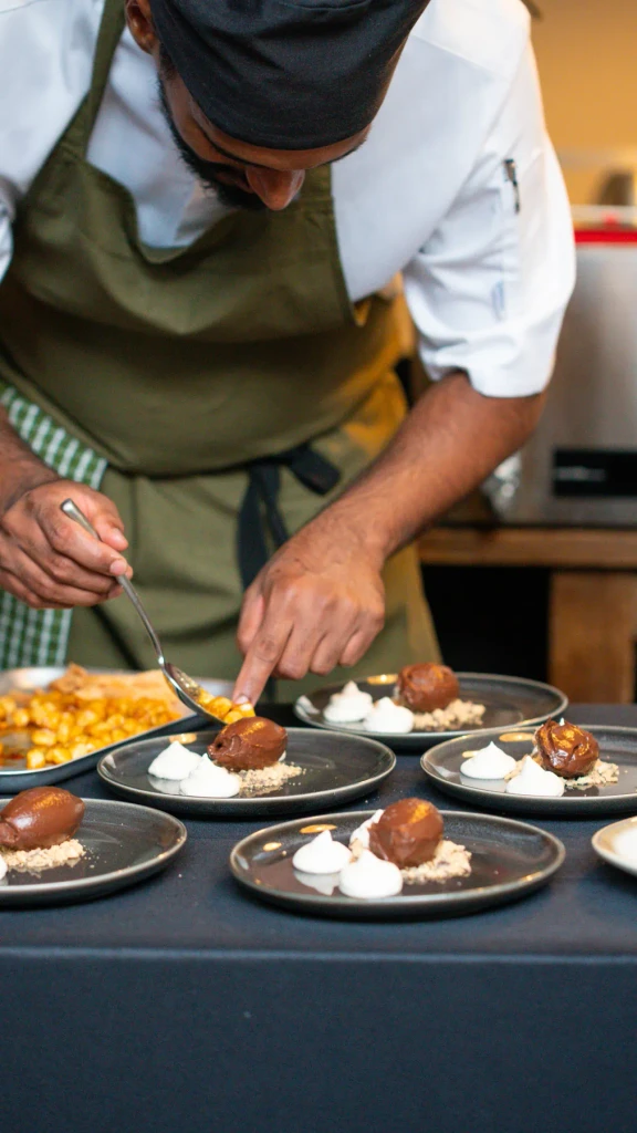 Josh plating chocolate desserts in his apron