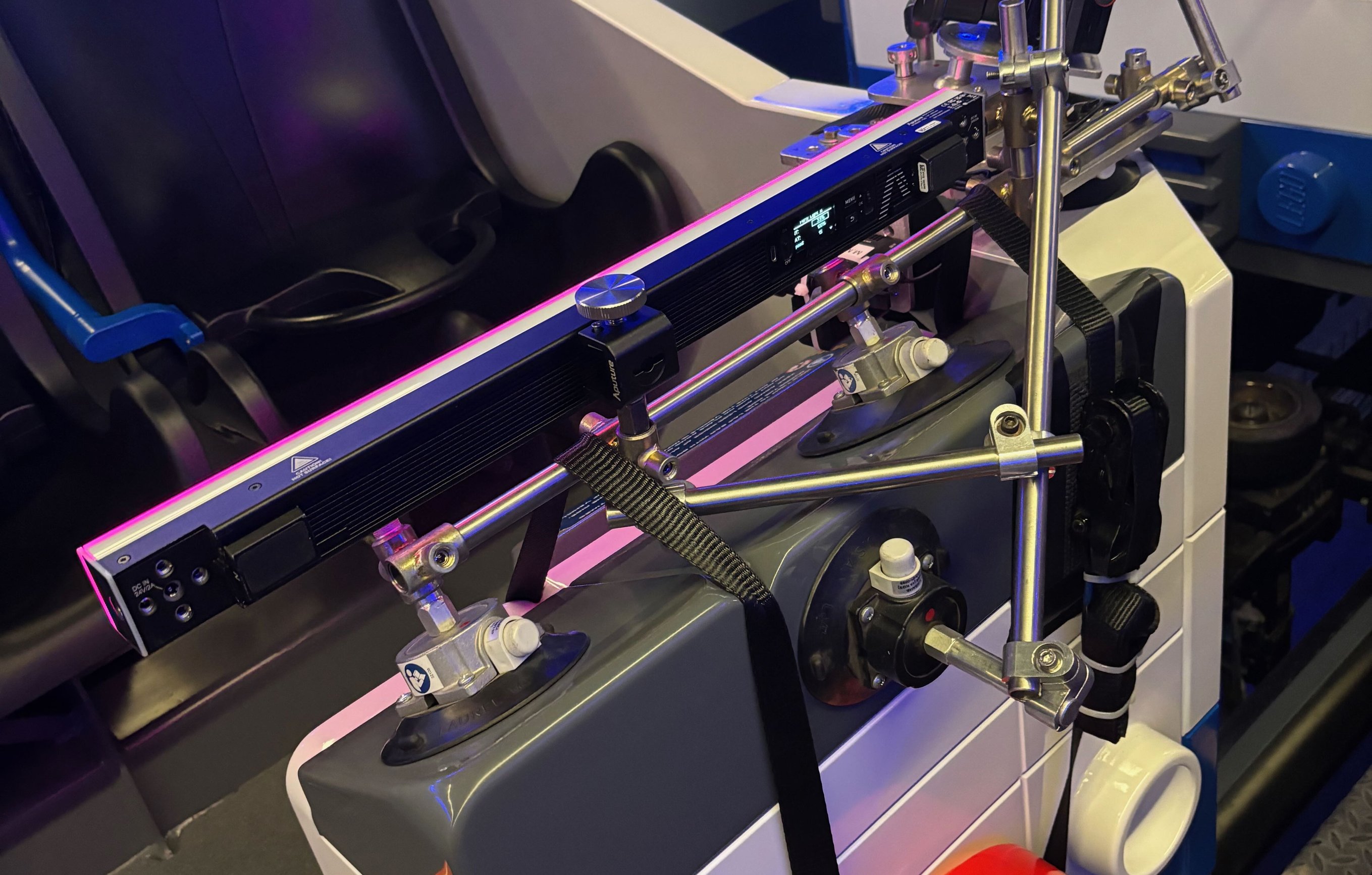 Legoland coaster rig hardware detail showing speedrail, baby pin, and hard-mount assembly on the nose of the coaster car