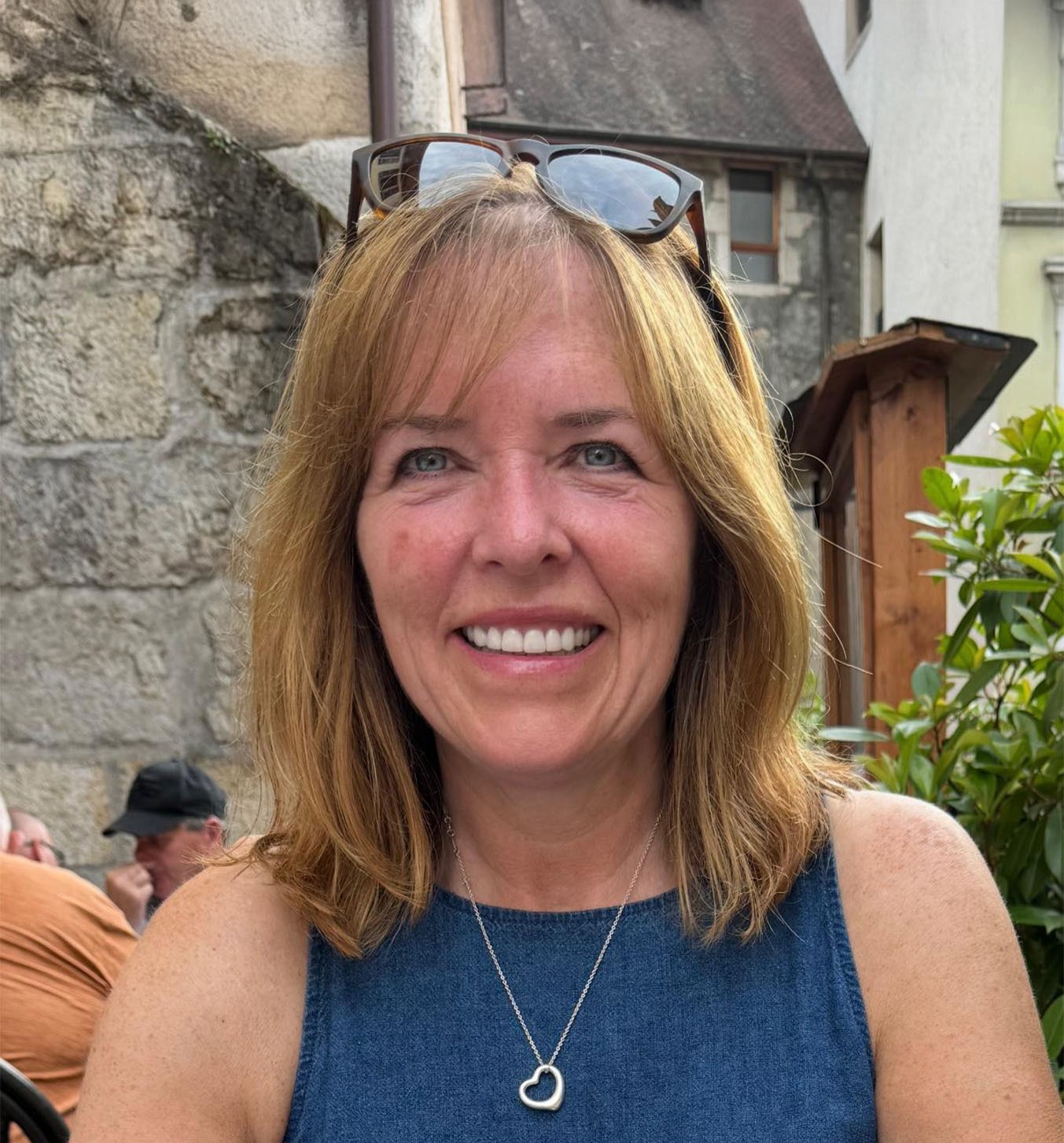 Cartoon girl with brown hair and orange sweater