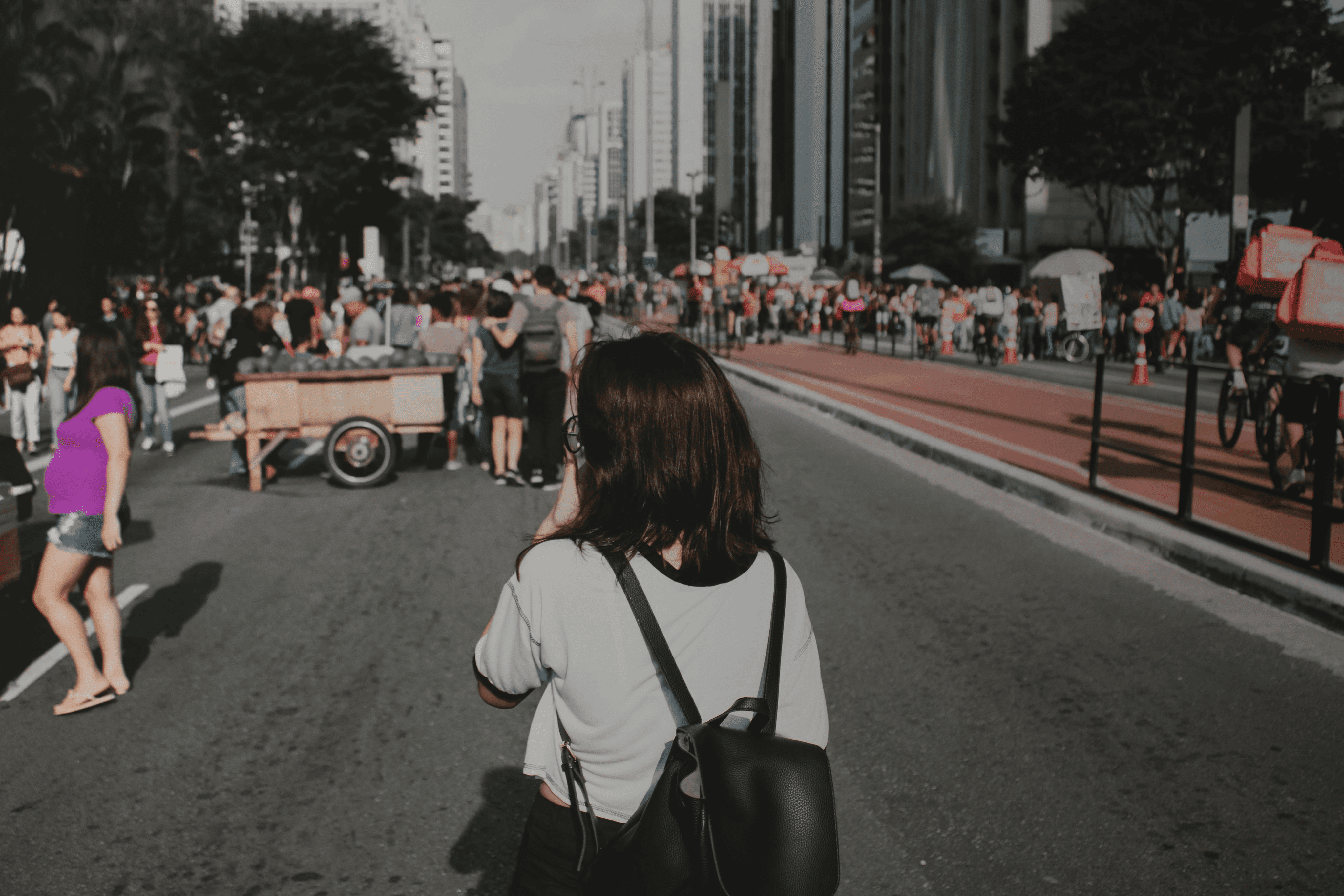 a woman with braids walking down a street