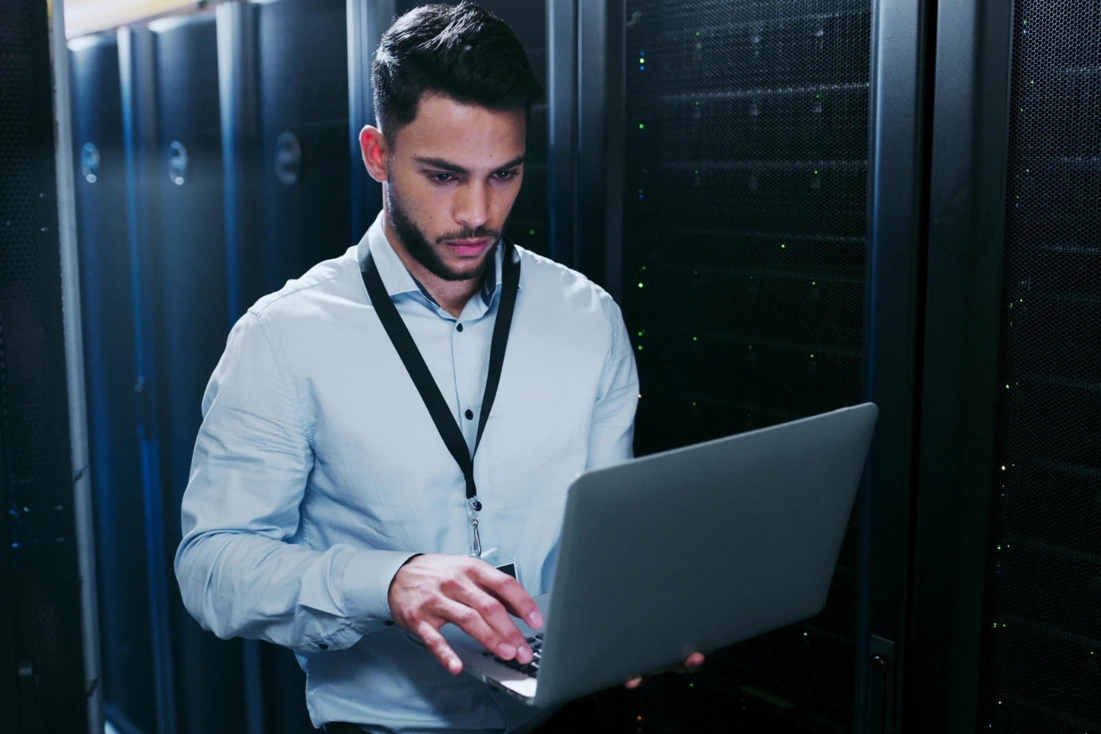 IT‑Administrator arbeitet am Laptop im Serverraum
