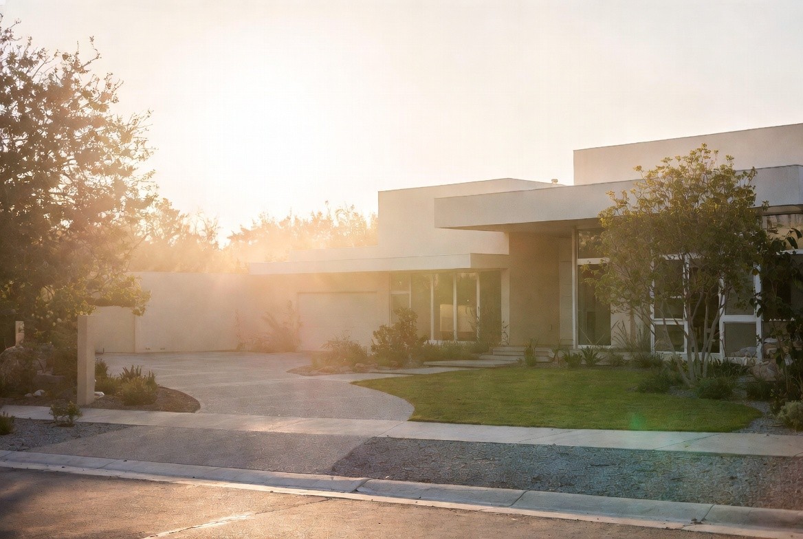 Modern single-storey home exterior with curved driveway at golden hour
