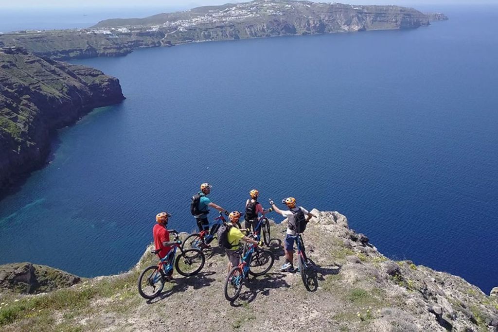 Cyclist on the edge of a cliff looking into the distance