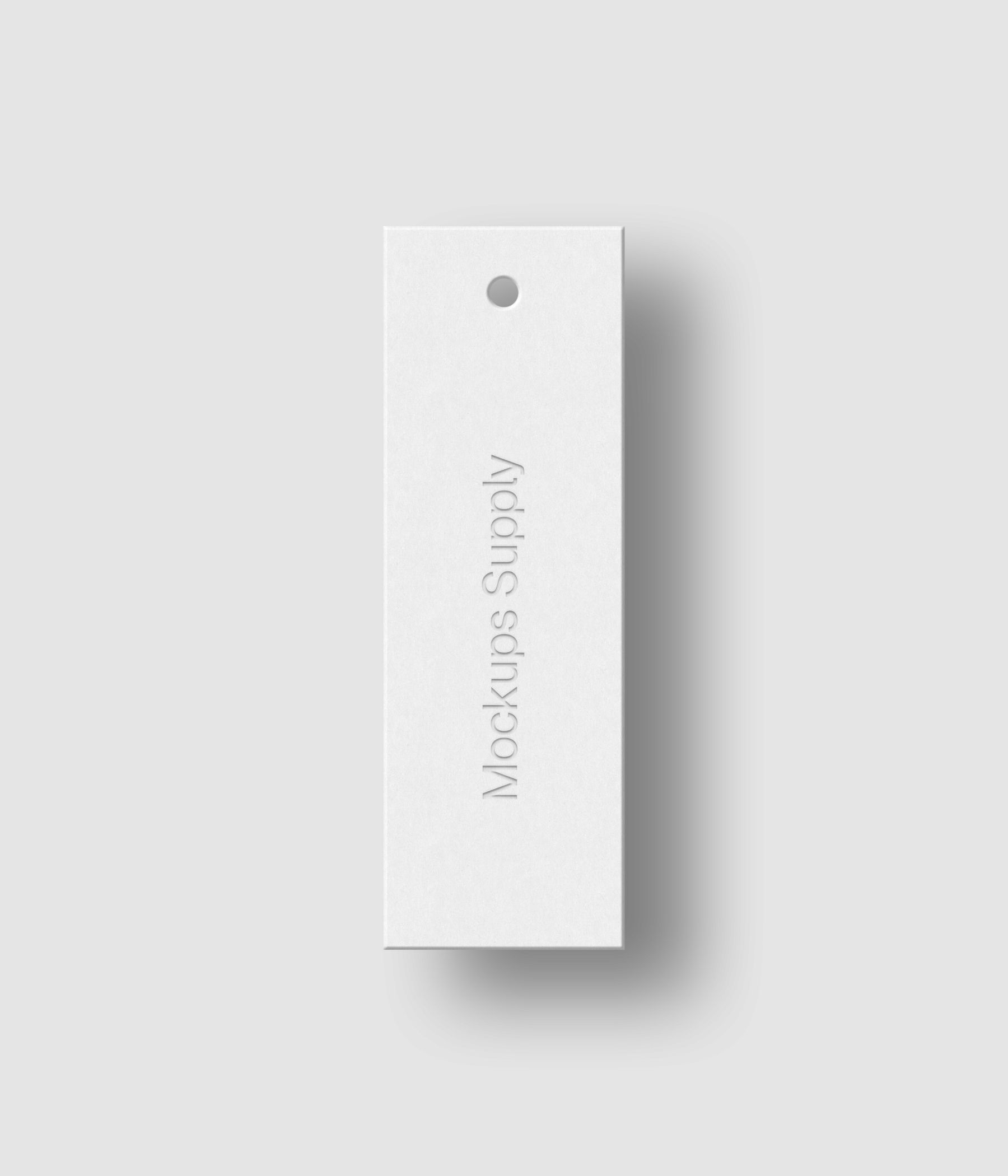 White 1x3 vertical hang tag mockup on white background with soft shadow and debossed text effect for Photoshop download psd