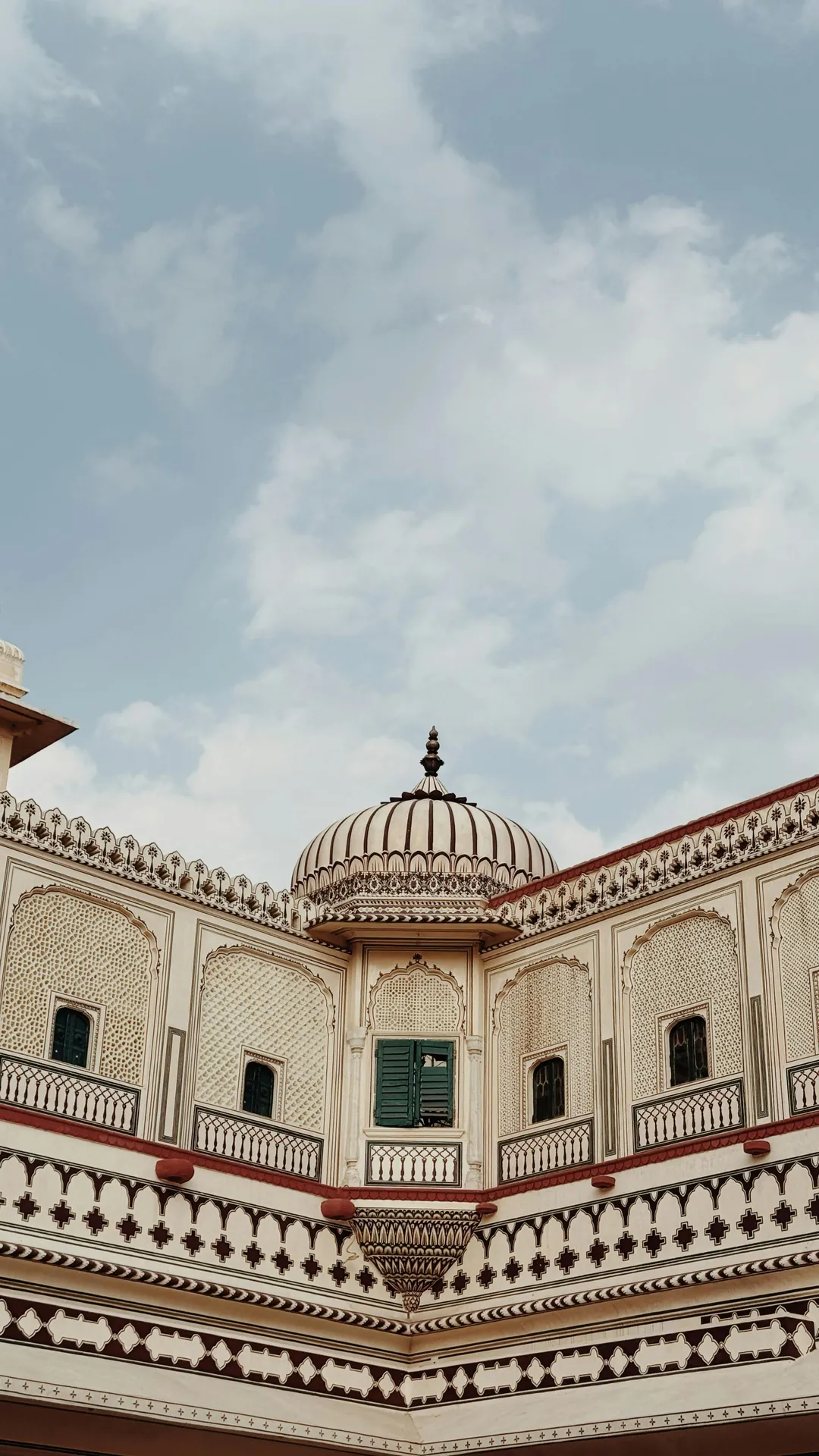 red train travelling near body of water