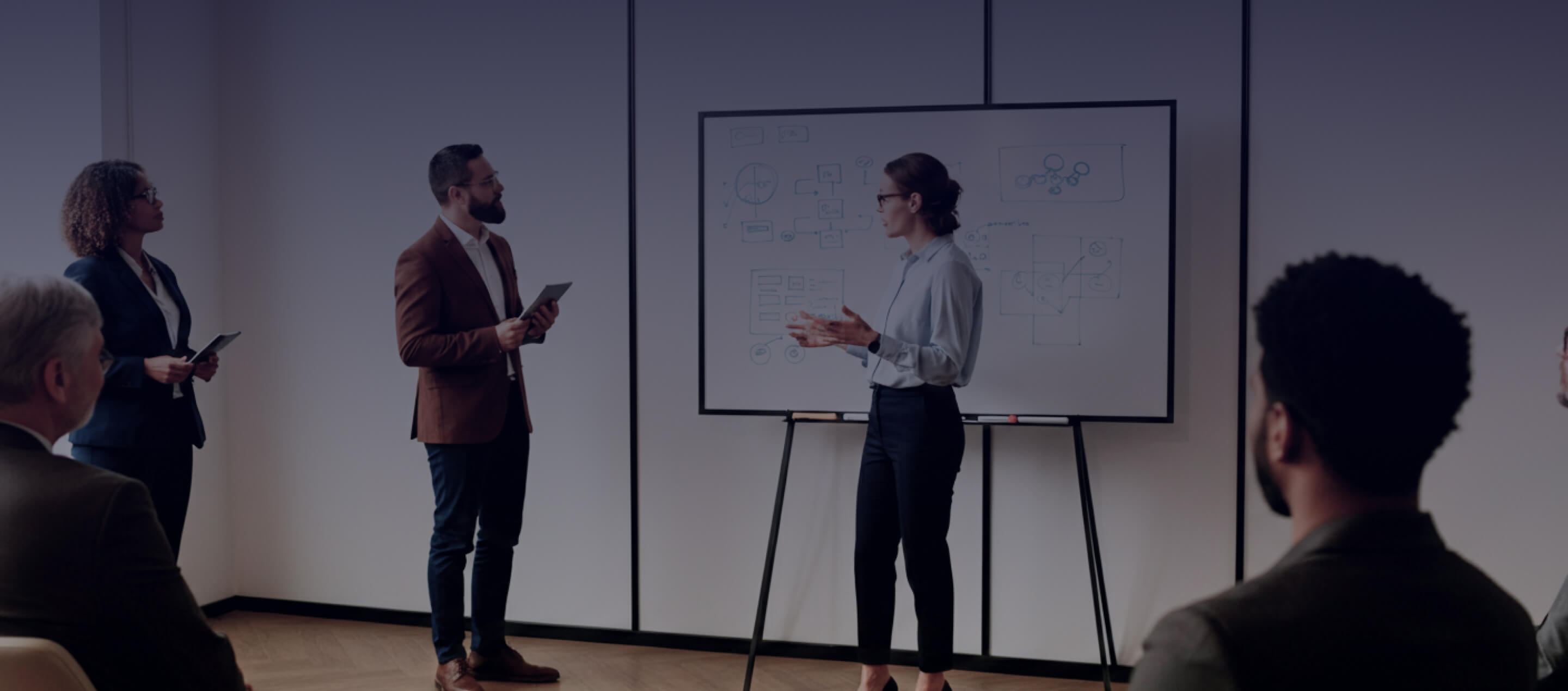 Two team members talking in a bright open conference room.