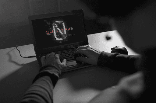 Laptop showing “Access Denied” warning, symbolizing cybersecurity risks and the need for verified digital safety with Profiled Nigeria.
