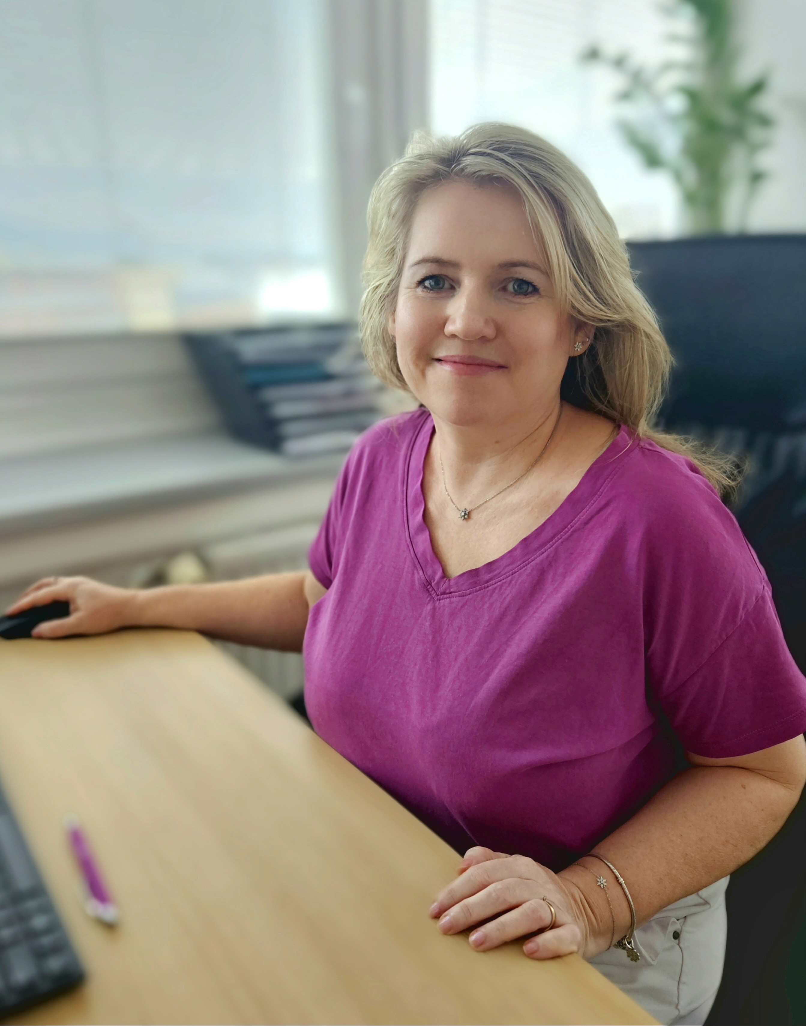 a woman in a white lab coat pointing at something
