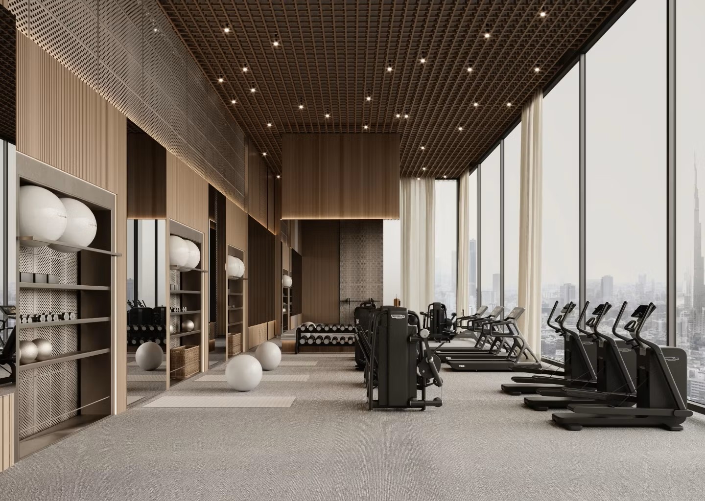 A gym room featuring large windows that showcase a panoramic view of the city skyline.