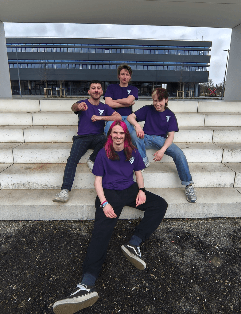 The full DDI team sitting together on stone steps outside