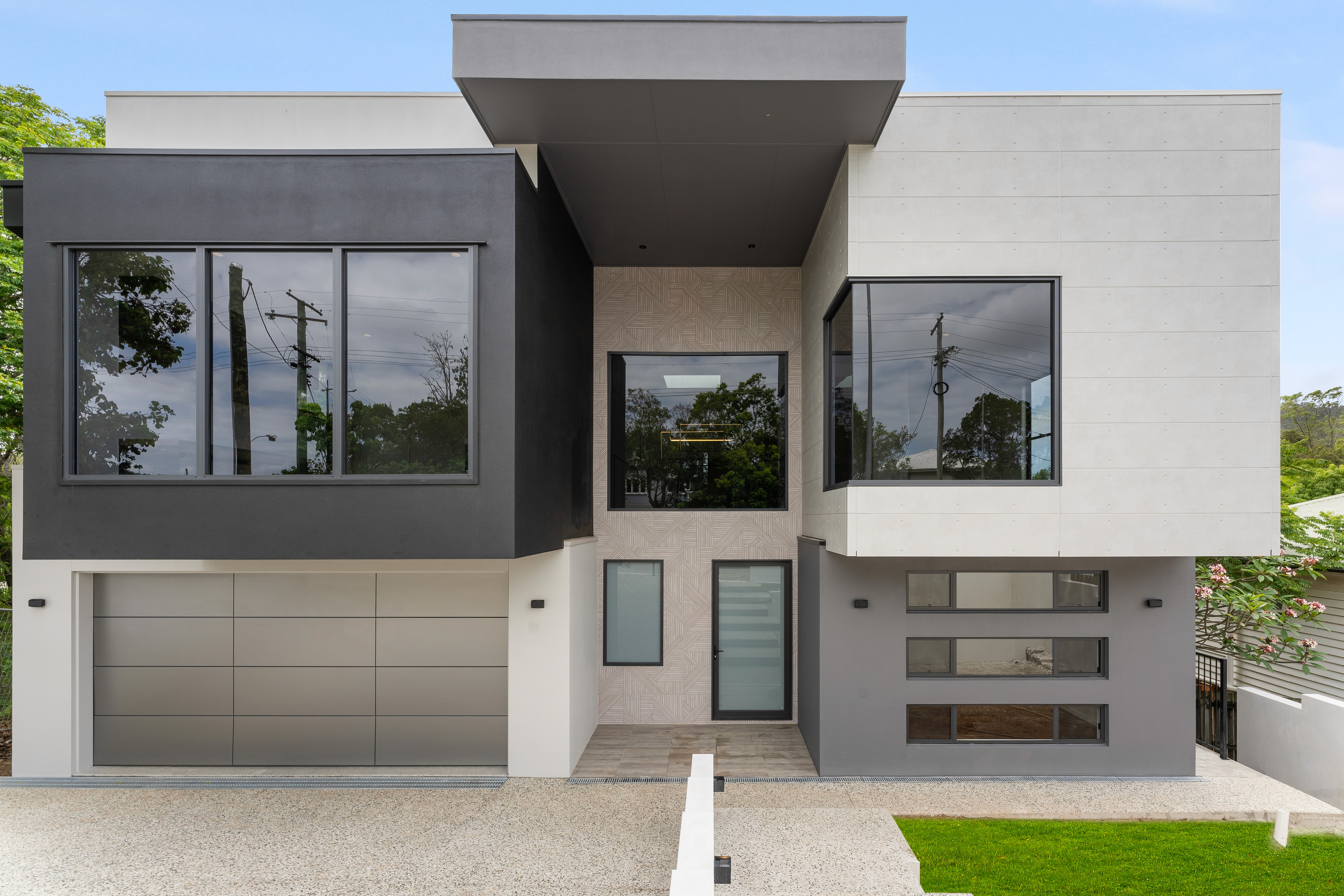 A modern home design in Brisbane featuring clean structural lines and large glazing.