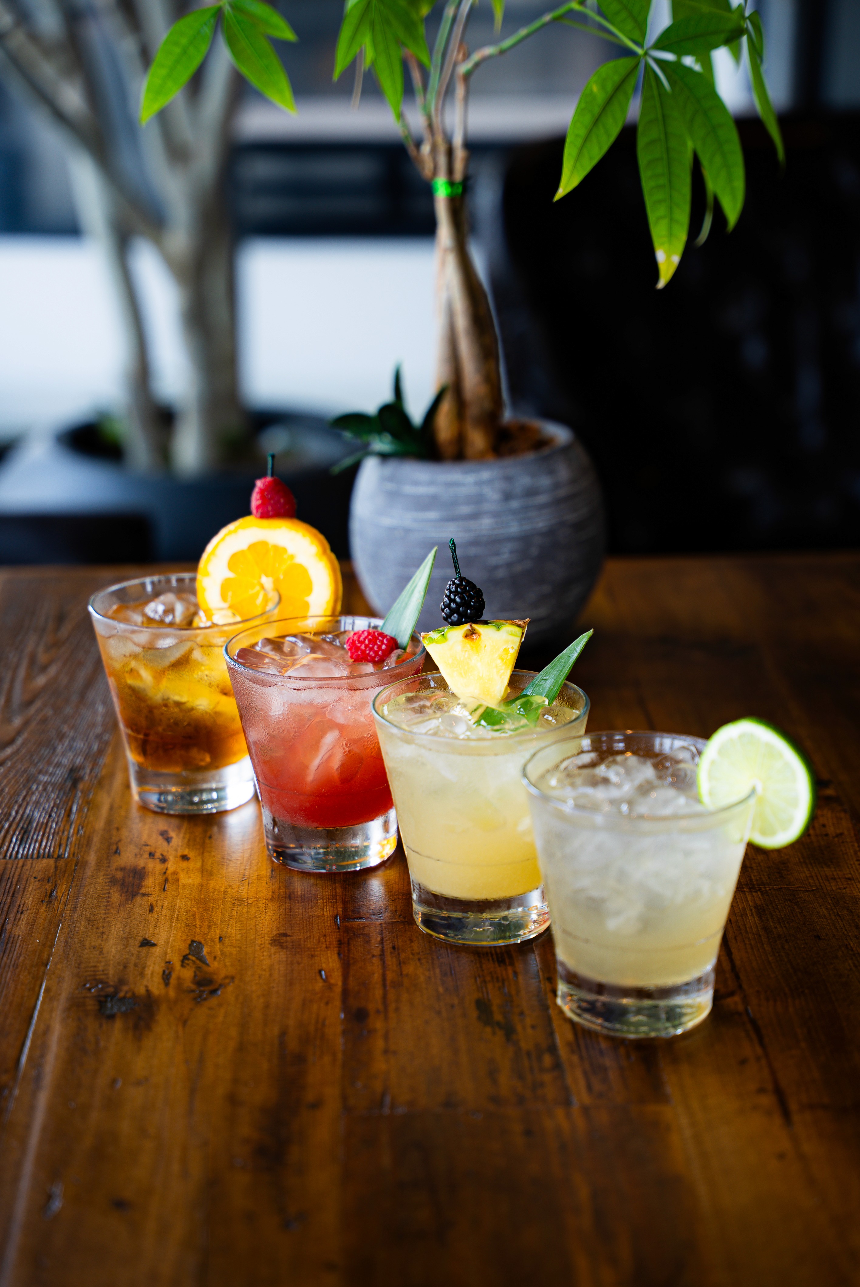 clear drinking glass with coffee on top of white table
