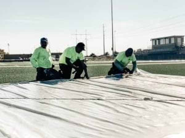 Running track rebuild in progress with crews preparing the base and drainage layers before installing a new surface system.