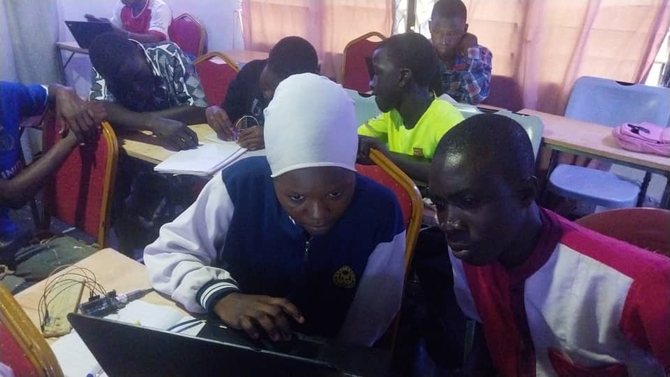 Youth students learning to code on laptops at the Bitcoin Dua Education Center in Agbozume, Ghana